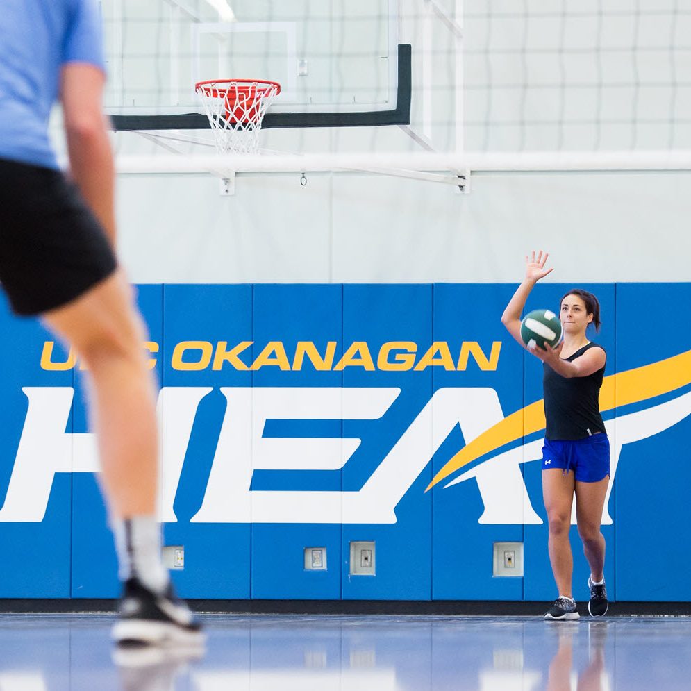 A volleyball player preparing to serve the ball.